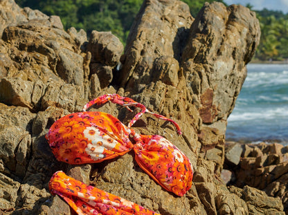 Trend Ripple Customer posing on the rocks with floral bikini set